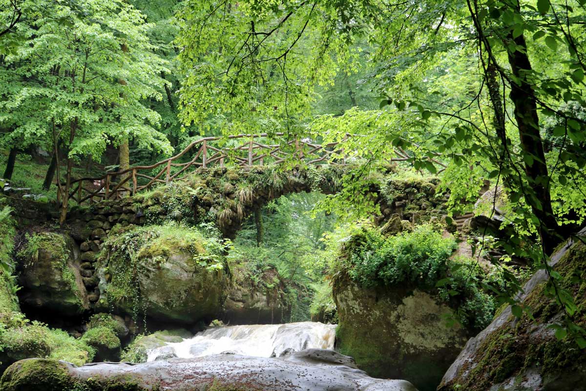 moss covered bridge on mullerthal trail in luxembourg